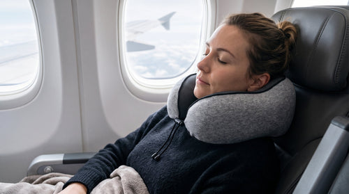 Woman sleeping on a plane wearing the Memory Foam Travel Pillow